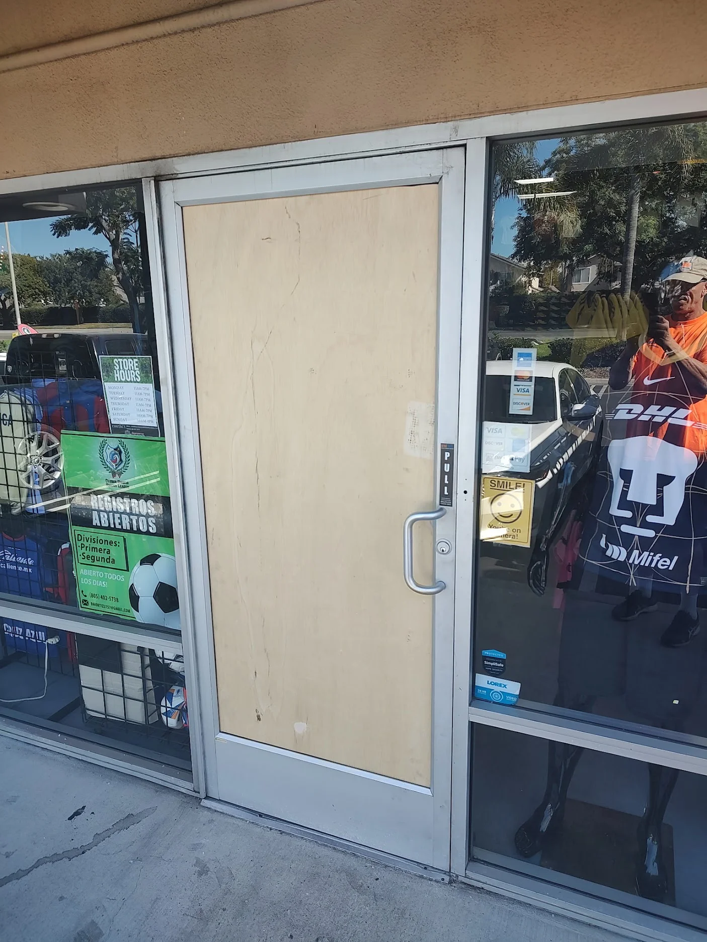 Emergency door and window board-up service securing a damaged storefront in Oxnard, CA
