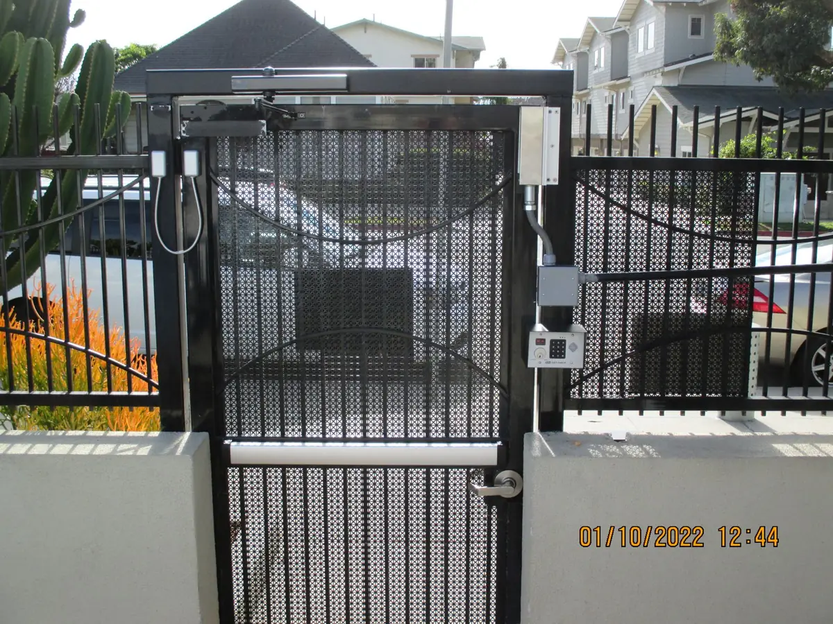 Magnetic lock and access control hardware installed on a gate entrance