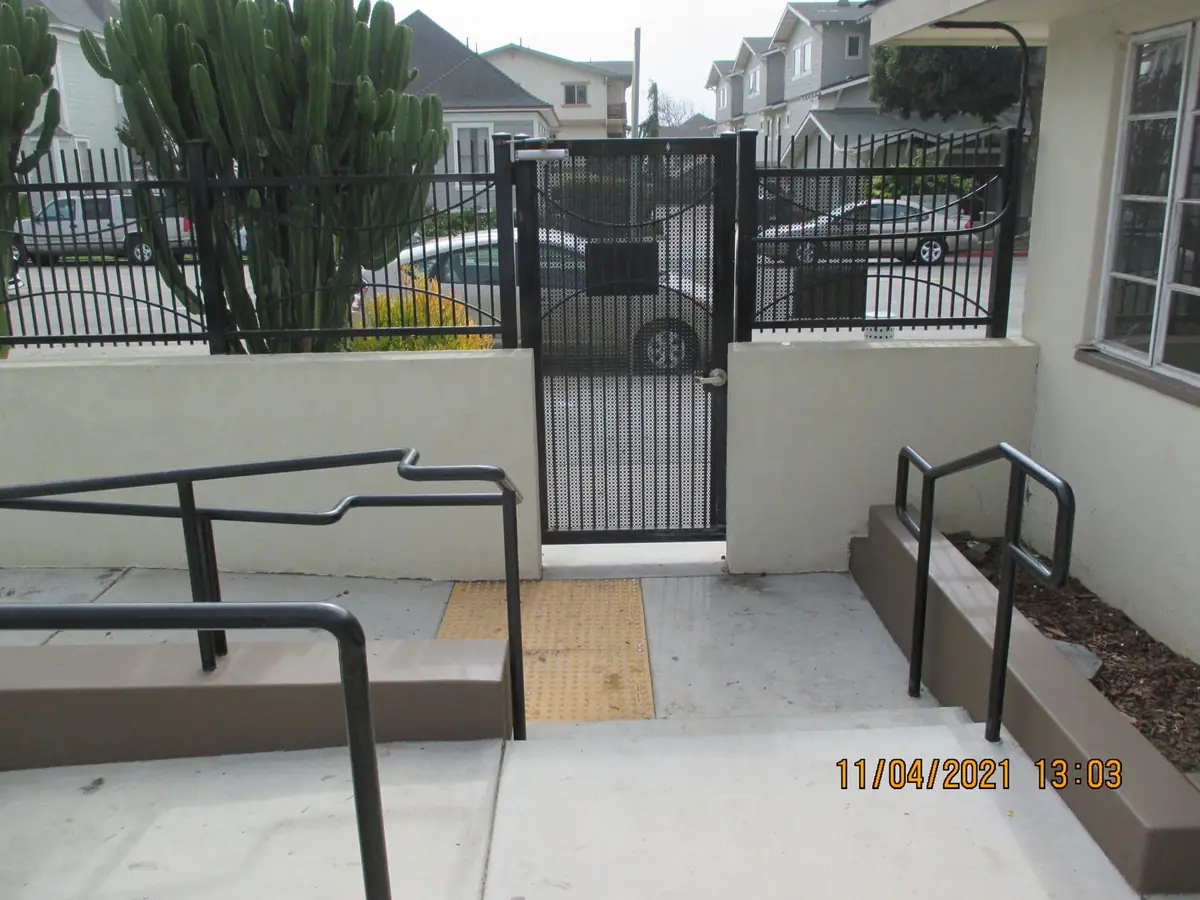 Security gate repair and hardware adjustment on a commercial property gate